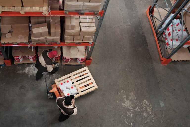 High angle view of workers organizing inventory in a warehouse.